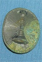 Early raised fire trumpet badge