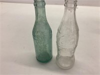 Two old Coke bottles