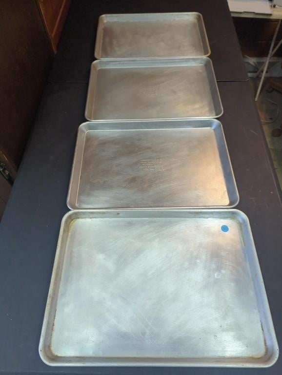 Four heavy half sheet trays