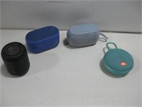 Four Portable Bluetooth Speakers Powered On