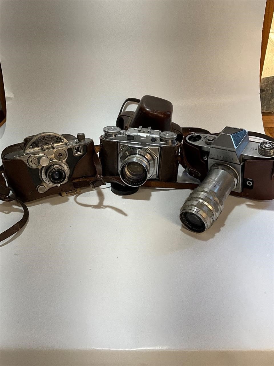 A neat collection of Cast Iron, Cameras, Lens, & Old Comm 64