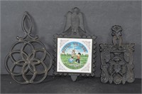 Two Cast Iron Wilson Trivets and One Holland