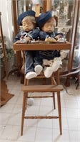 Twin dolls in highchair