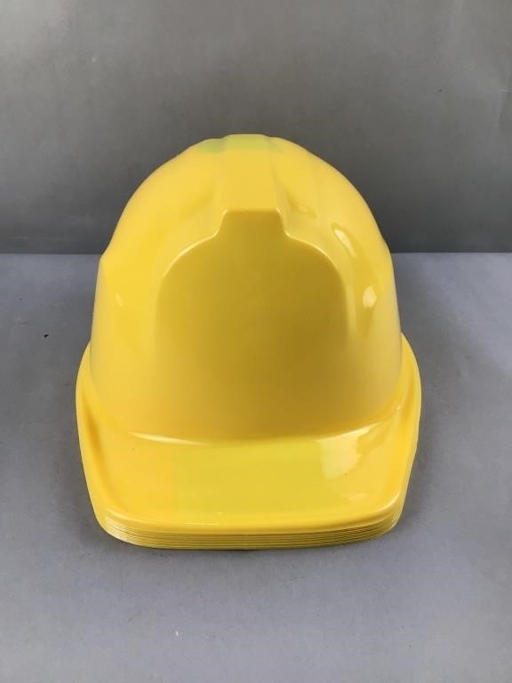 Stack of 12 plastic construction helmets