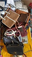 About 12 purses and bags, including a Kate Spade,