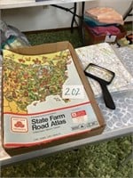 State Farm Road Atlas and a bunch of maps with a