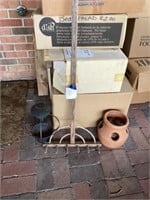 Wooden rake with hanging lantern and a planter
