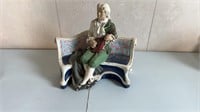 Man on Bench Playing Violin Statue