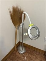 Magnifying lamp and broom