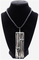 A Modernist/Brutalist Silver Pendant on braided