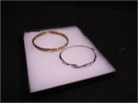 Two sterling bangle-style bracelets, one is