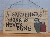 Wooden sign "a gardeners work is never done"