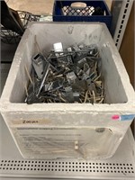 Bin of assorted retail wall grid hangers.