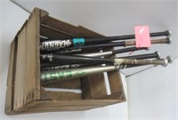 Metal baseball bats in wood crate.