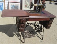 Antique Singer sewing machine with cabinet.