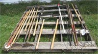 Pallet full of various yard tools including