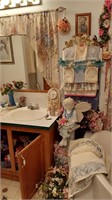 Angel on stool, floral, towels & cabinet contents