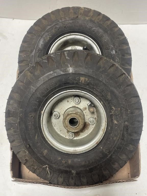 Pair of 4.10/3.50-4 tubed tires on rims.