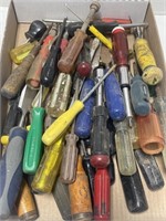 Large assortment of screwdrivers and wood