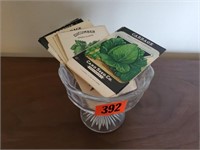Glass pedestal dish, seed packets