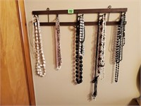 Wall hooks, beaded necklaces, costume jewelry
