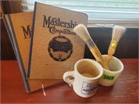 Mug, paintbrushes, composition books