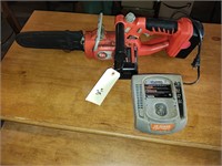 Chain saw with battery and charger.
