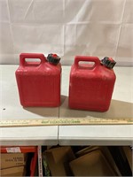 2 one gallon gas cans, even have a little fuel