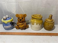 four small honey jars