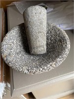 An unpolished heavy granite mortar and pestle