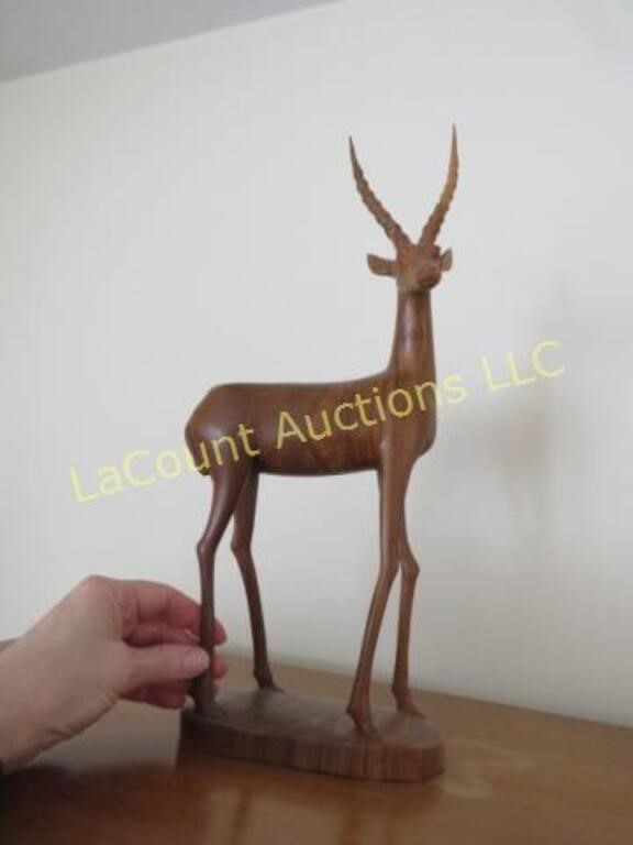 large wood carved antelope