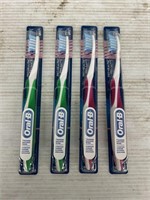 Oral-B 4 packs of toothbrushes pink and green