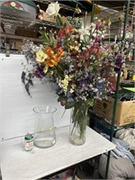 Decorative glass vases full of fake flowers