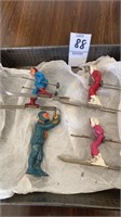 3 cast downhill skiers 2 1/2 inches and a cast