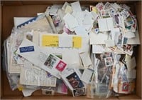 Box of Loose postmarked stamps Some unused/