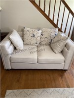 White loveseat, and throw pillows