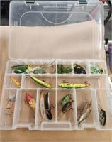 Assorted fishing lures and cabela's case