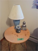 Table With Lamp Candle And Buddha Figure