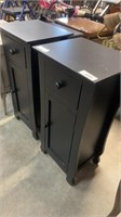 Pair of black and tables with doors and drawer