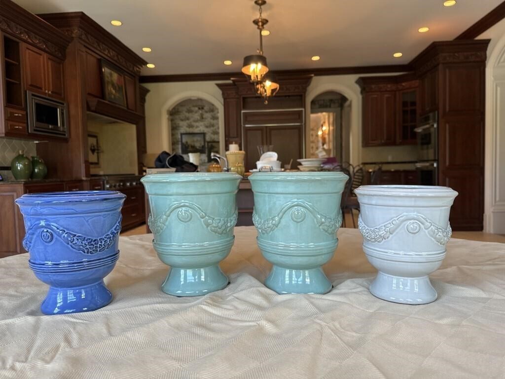 Four graduated pottery planters, tallest are 8.5