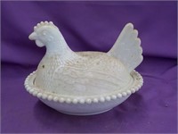 White milk glass chicken on nest