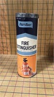 Old fire extinguisher in cardboard can