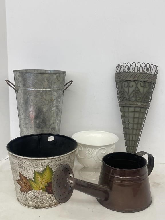 Variety of plant containers and watering can.