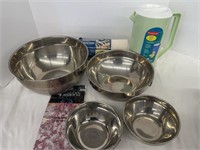 Four stainless steel mixing bowls, a Rubbermaid