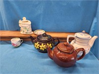 3 teapots, sugar jar, cup, saucer and plate