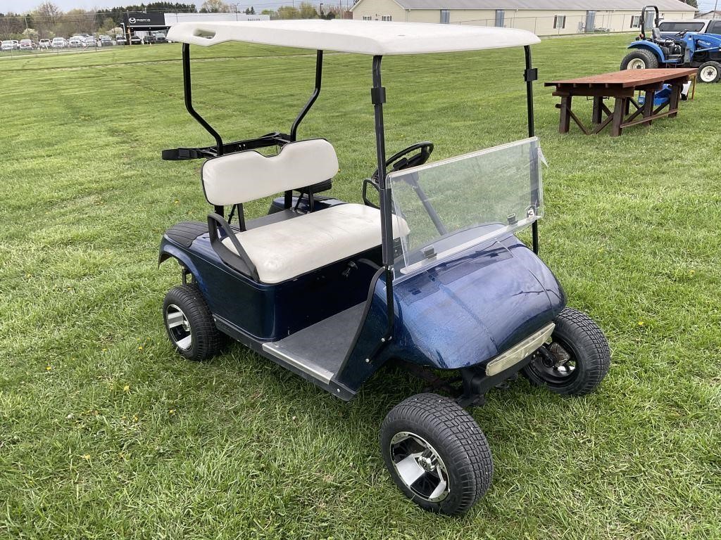 Blue EZGO golf cart, with “Jake’s” lift kit