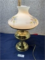 brass colored lamp with floral shade