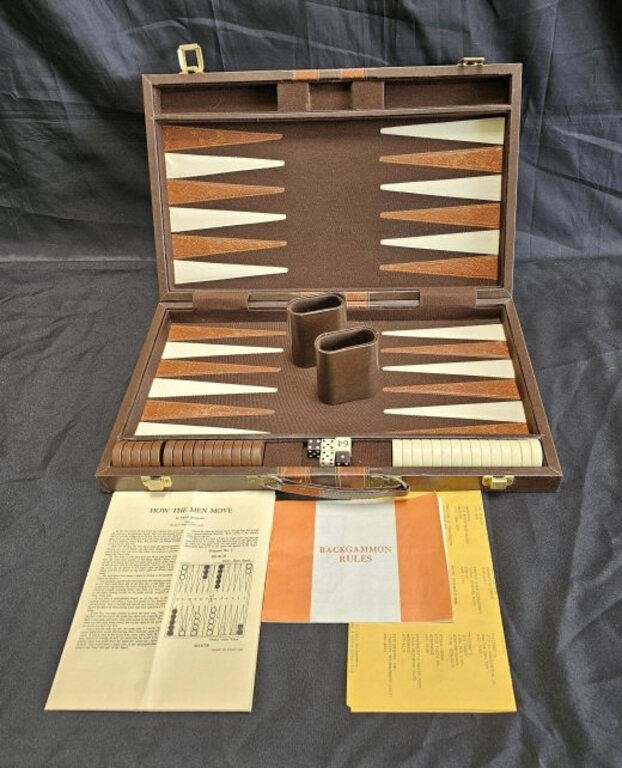 Vintage backgammon game in leather case, on floor.
