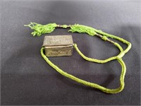 Silver pin box with green string