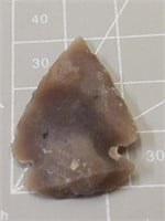A small gray arrowhead